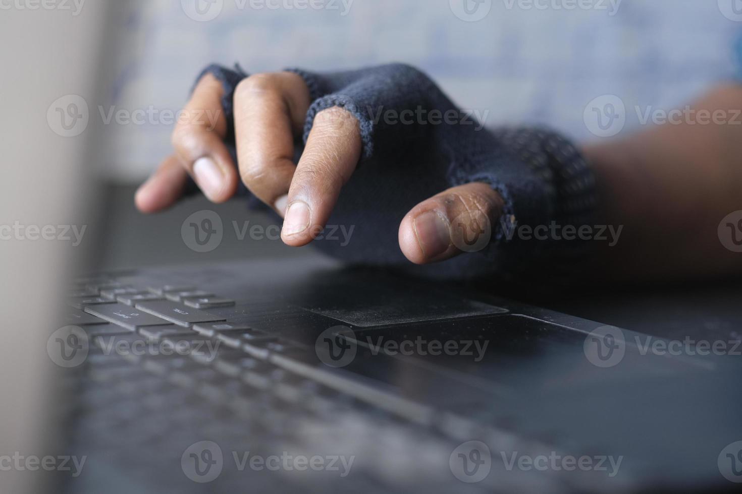 hacker hand stealing data from laptop top down photo