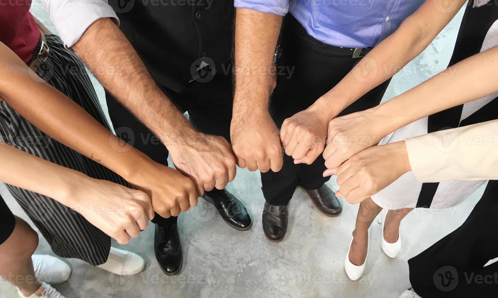 Successful business people standing together widen out showing strong relationship of worker community. A team of businessman and businesswoman expressing a strong group teamwork at the modern office. photo