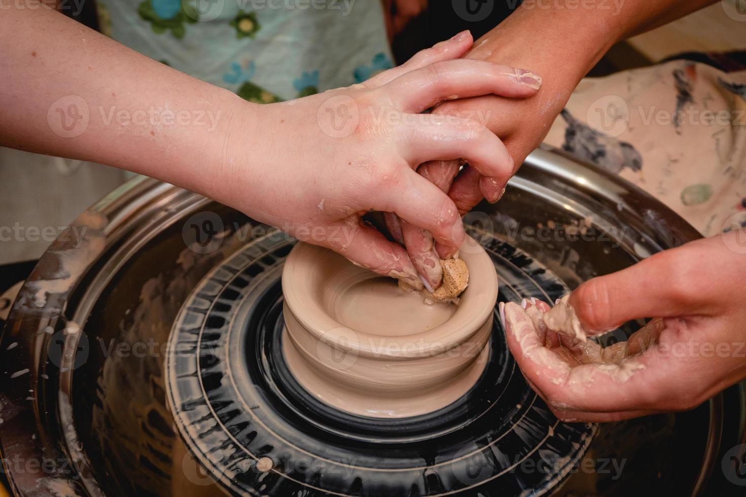 alfarero trabajando en torno de alfarero con arcilla. proceso de elaboración de vajillas de cerámica en taller de alfarería. foto