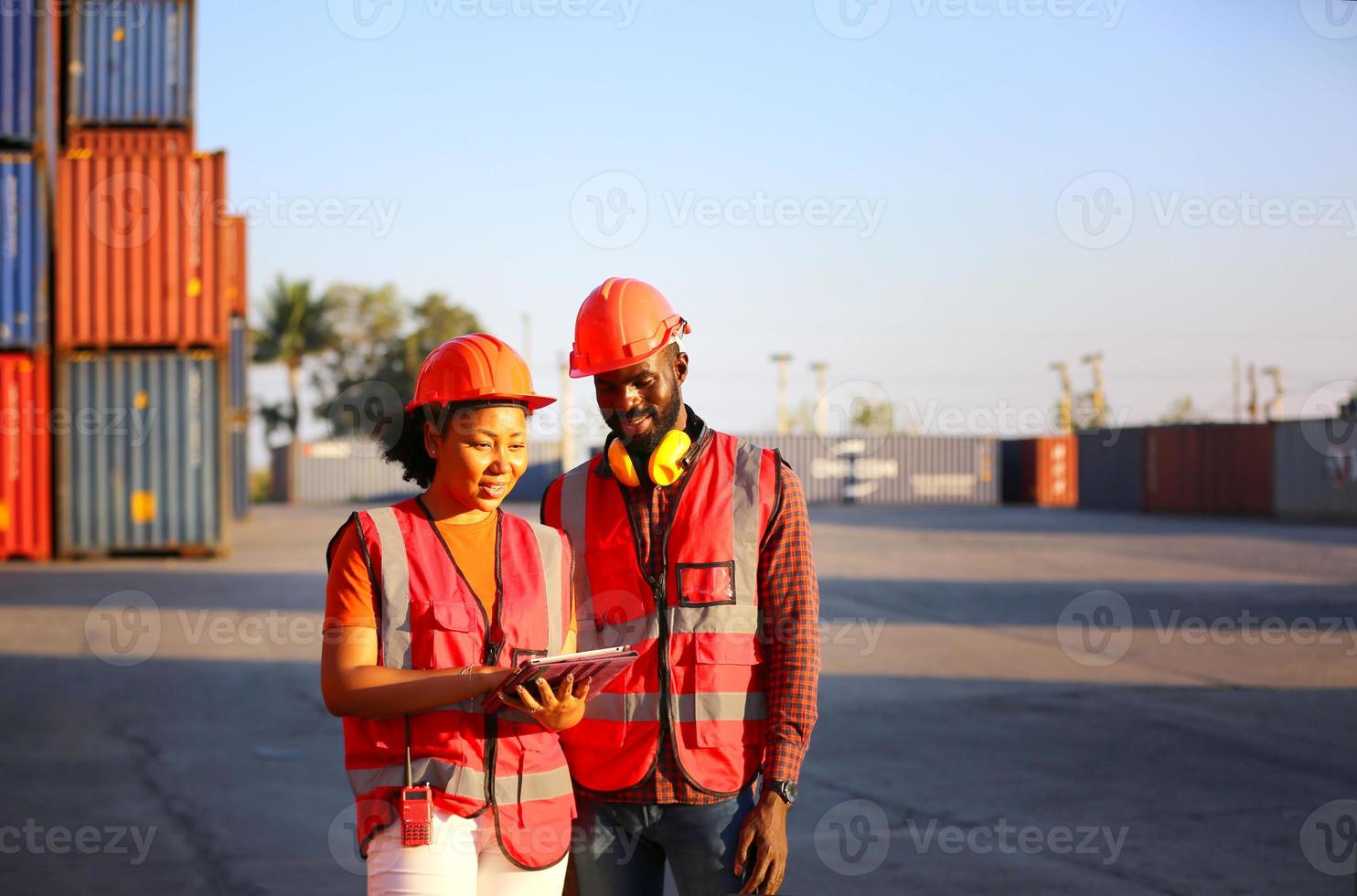 Foreman control loading Containers box from Cargo freight ship for import export. photo