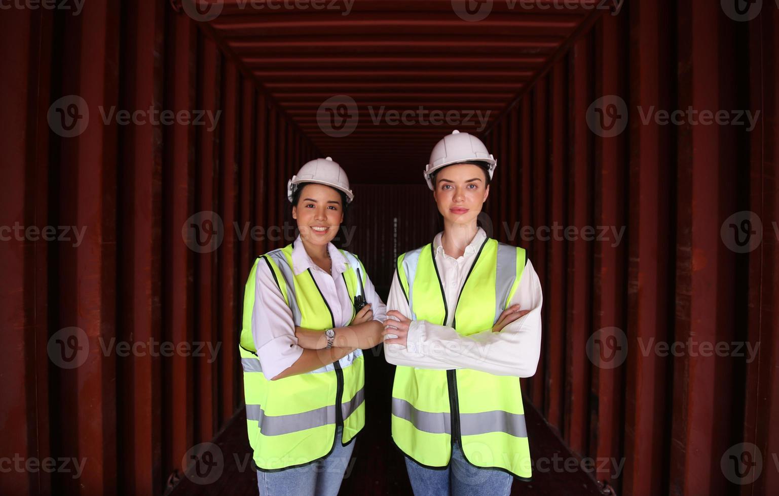 Foreman control loading Containers box from Cargo freight ship for import export. photo