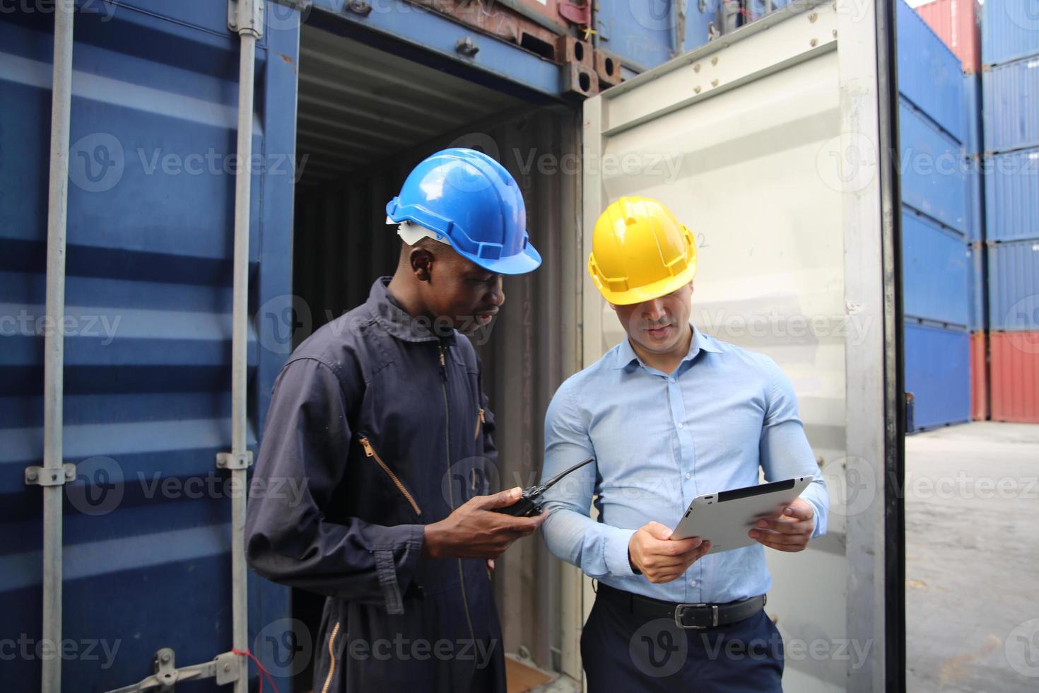 Foreman control loading Containers box from Cargo freight ship for import export. photo