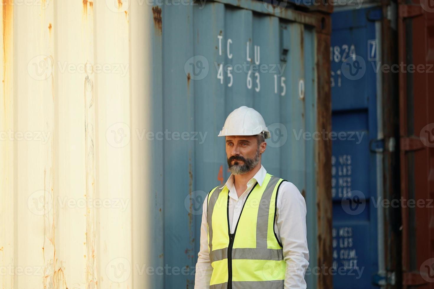 Foreman checking containers in the terminal, at import and export business logistic company. photo