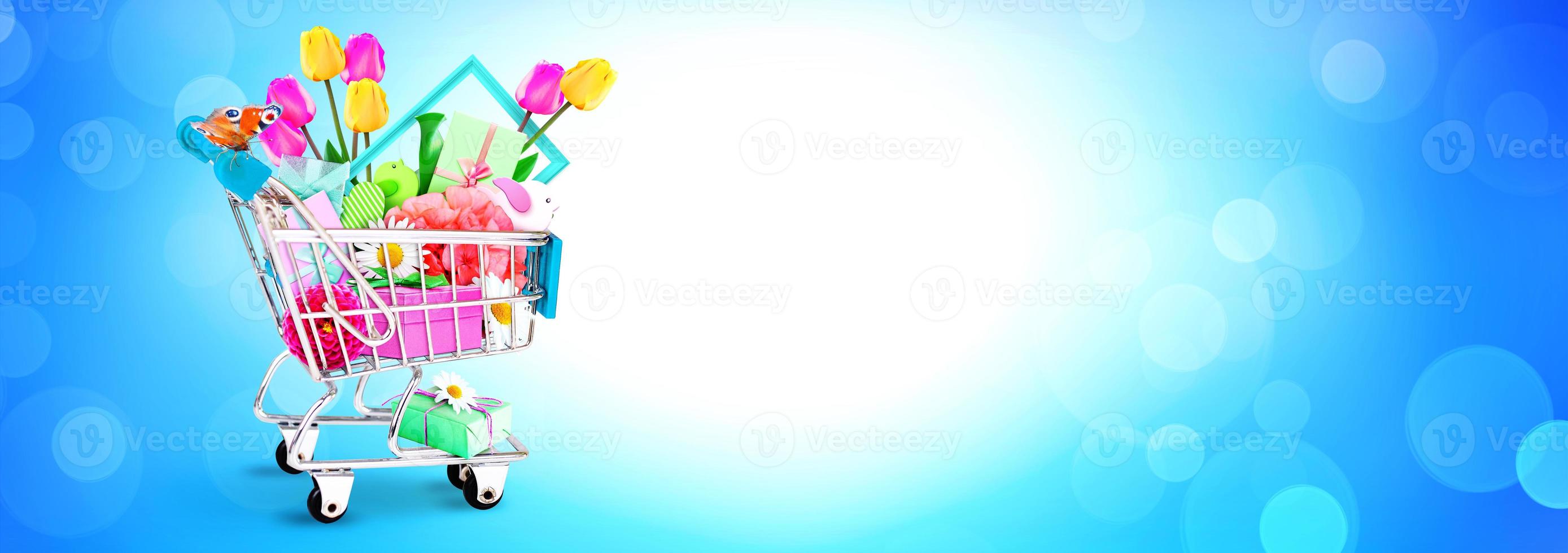 Mini shopping cart with colorful flowers and butterflies. photo