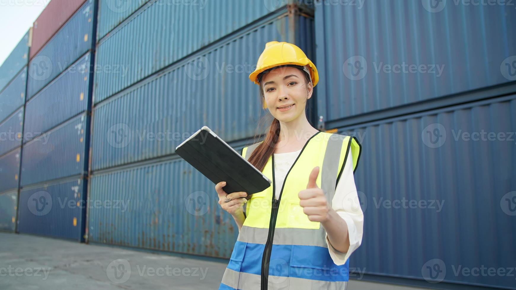 Female Foreman checking containers for ship at terminal port. photo