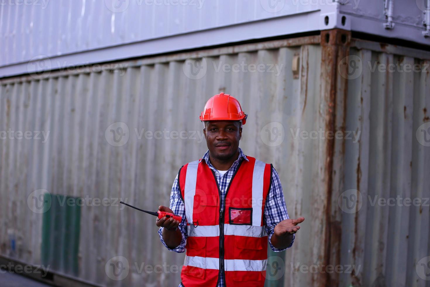 Engineer or supervisor checking and control loading Containers box from Cargo at harbor. Foreman control Industrial Container Cargo freight ship at industry. Transportation and logistic concept. photo