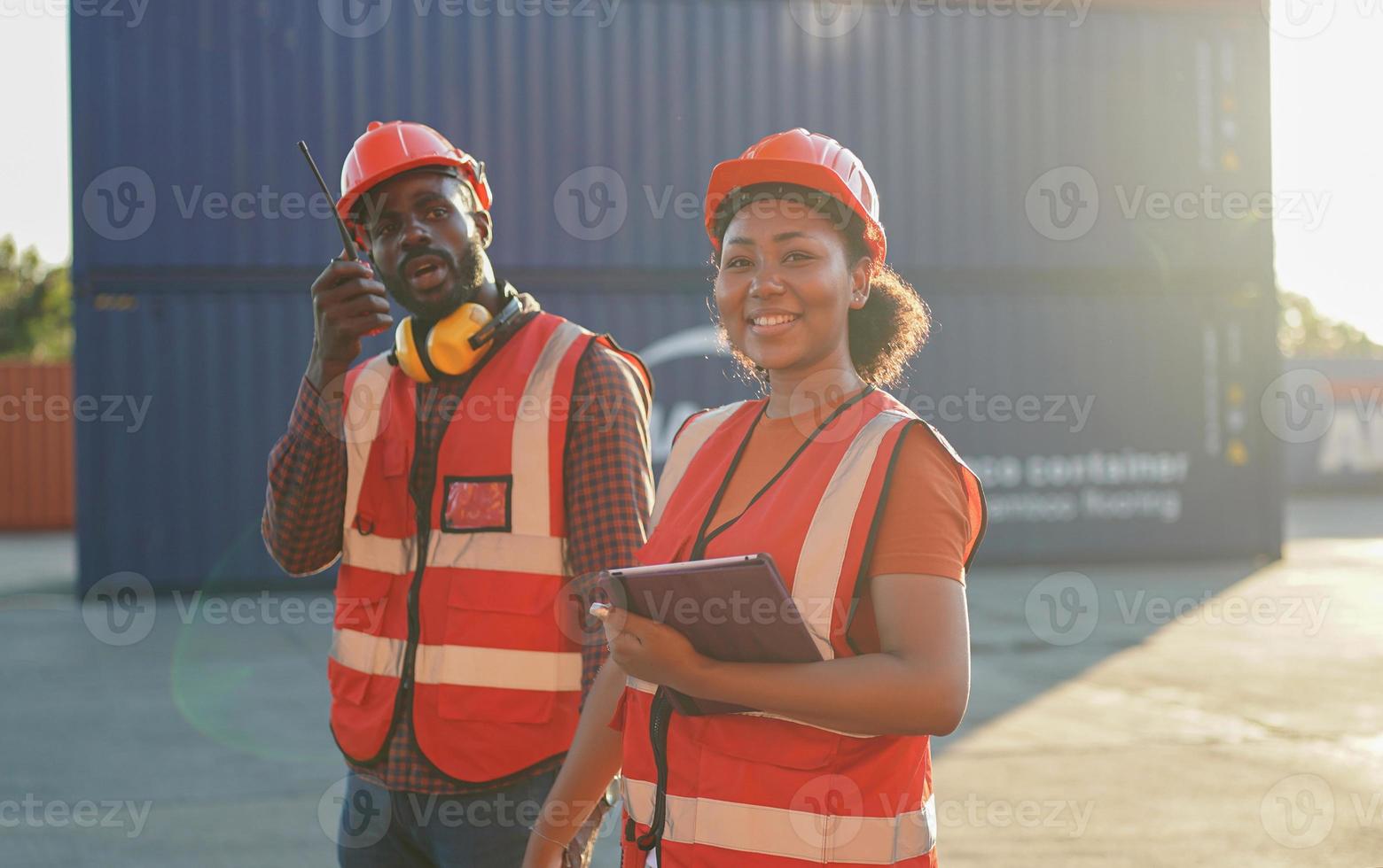 Foreman control loading Containers box from Cargo freight ship for import export. photo