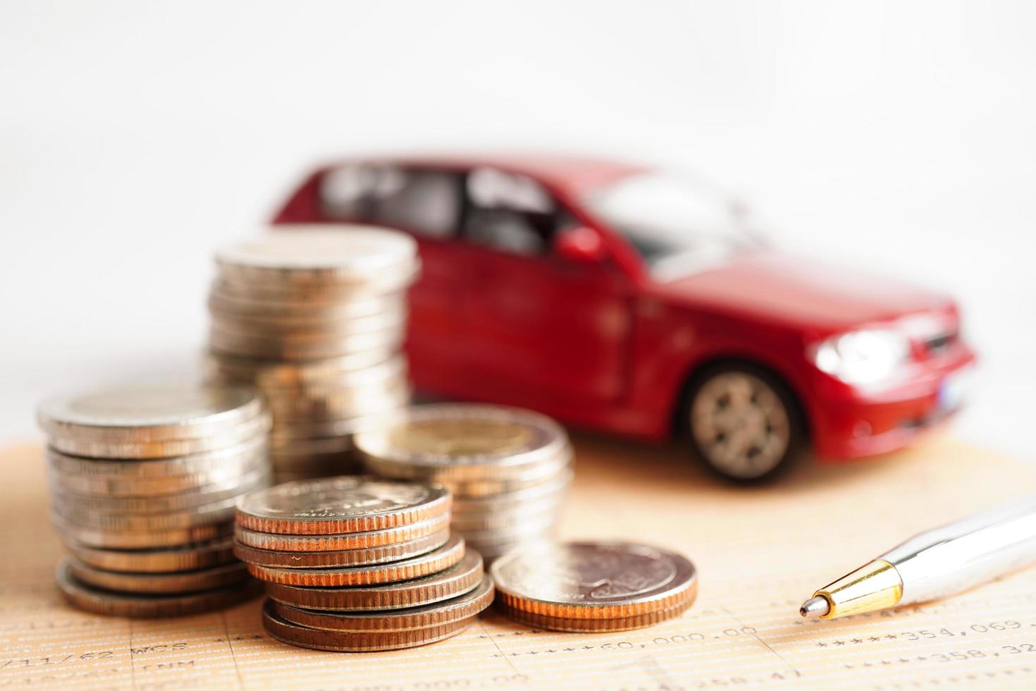 Car on coins money, saving bank, finance, installment payment, car loan interest. photo