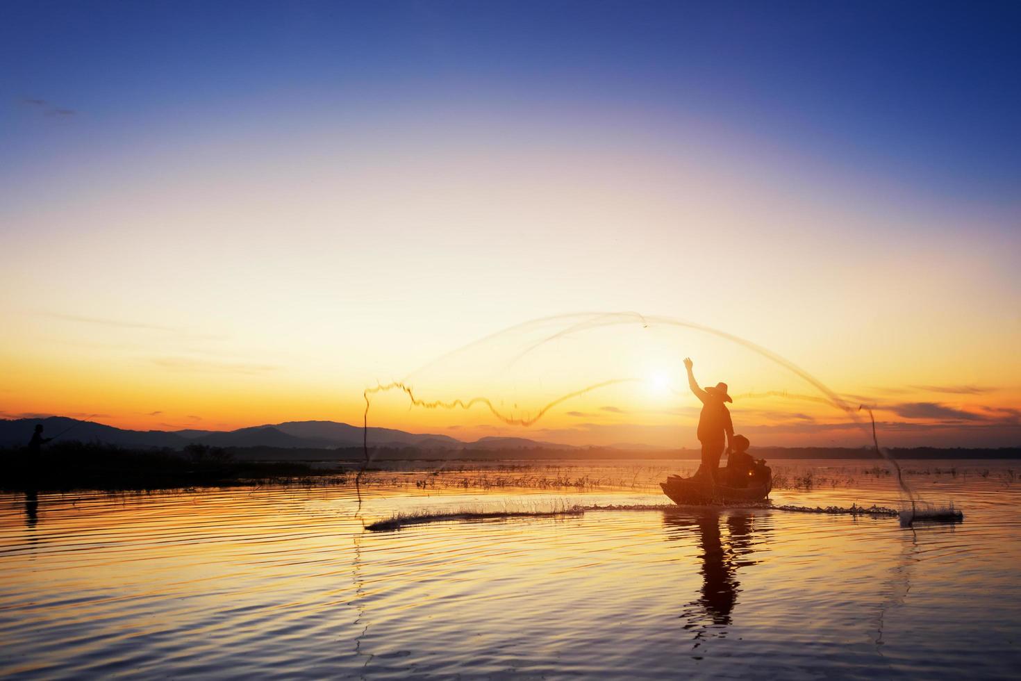 The fishermen are fishing by sowing their tweezers in the early morning hours. photo