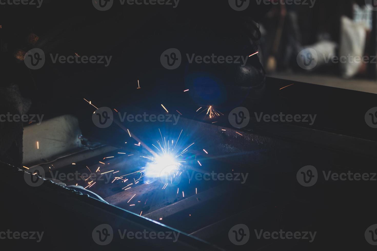 welder, welding automotive part in a car factory photo