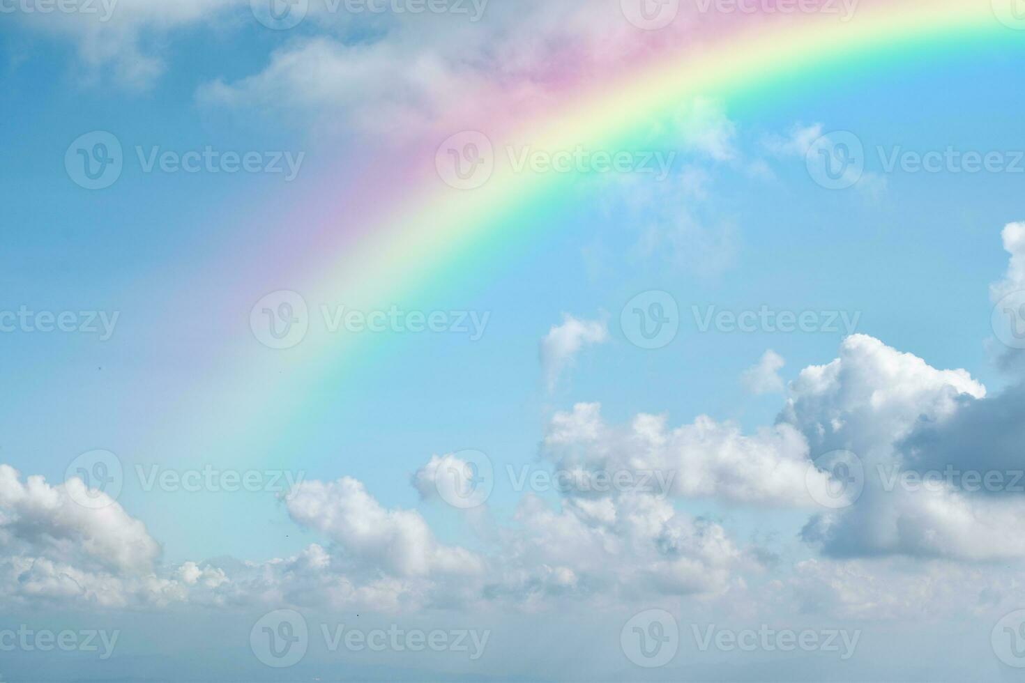 Rainbow on blue sky with white cloud background. photo