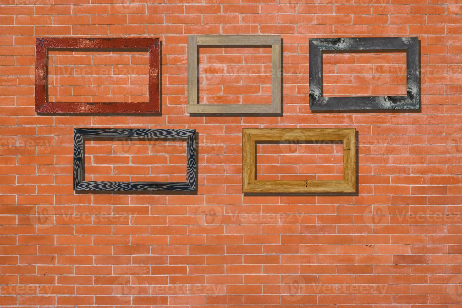 Vintage photo frames on brick wall for interior or background.