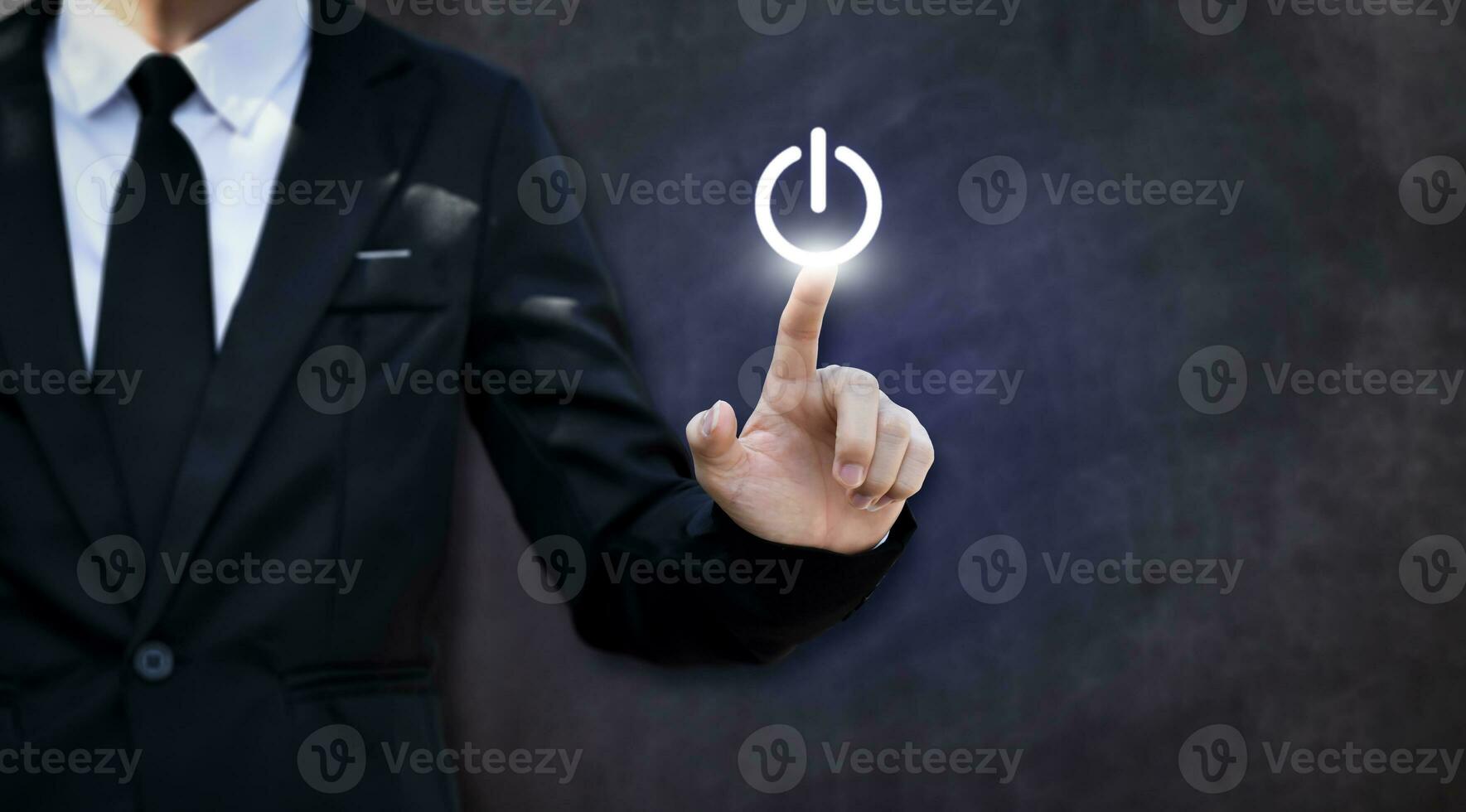 Businessman pressing power button. Concept of technology, internet and business. photo