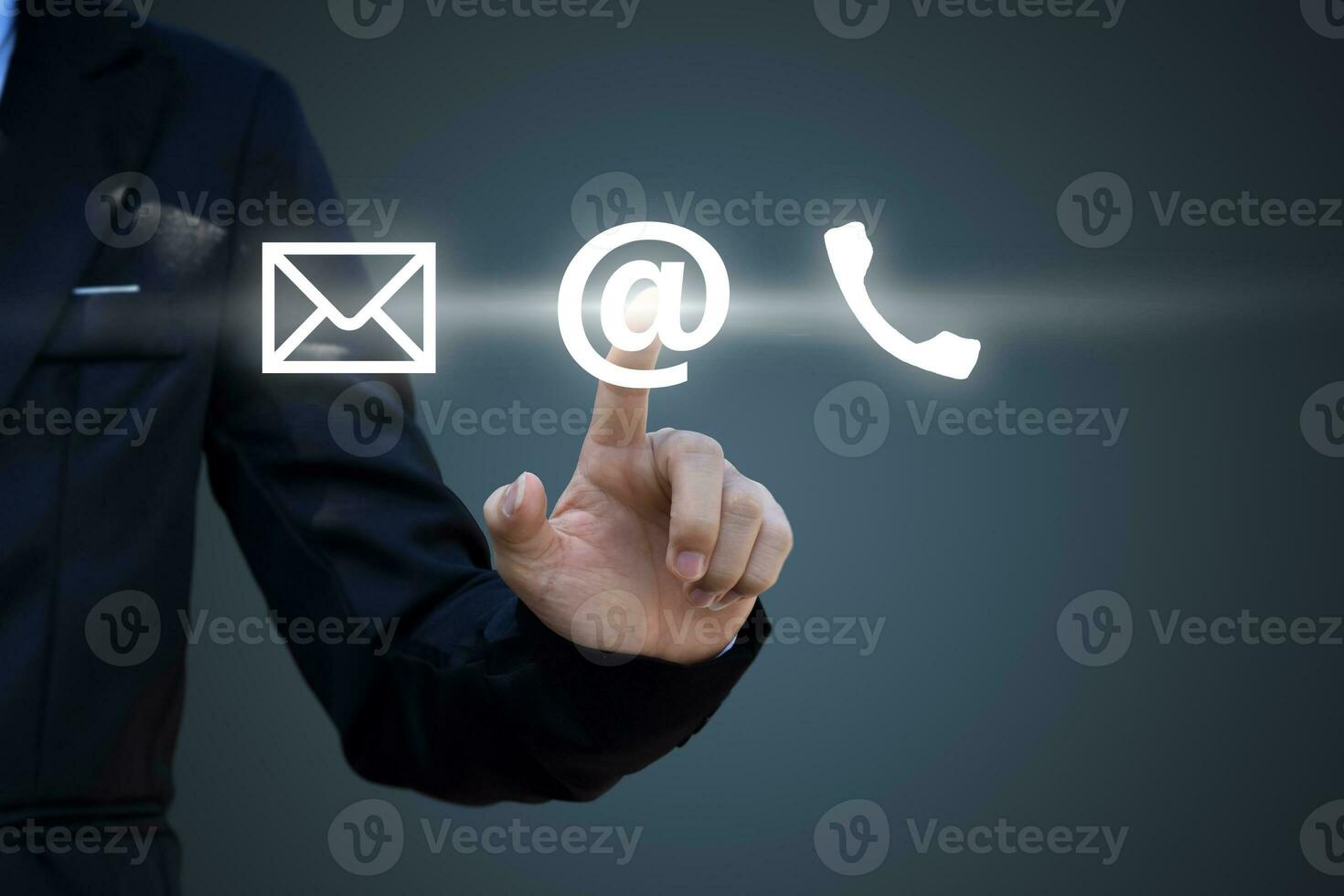 Hand pressing telephone, email button icon over blue background. Customer support concept photo