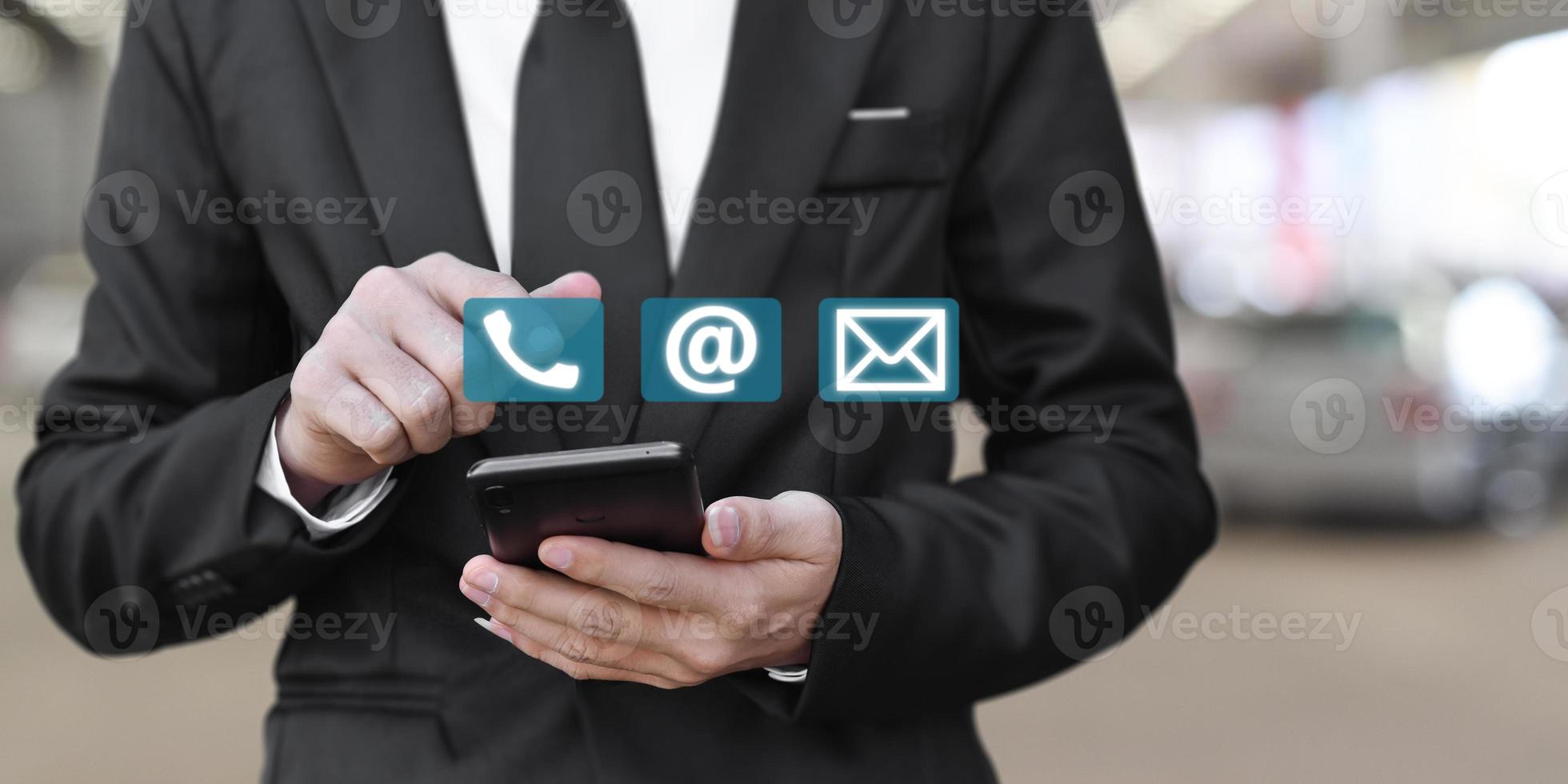 Businessman using mobile smartphone. Concept of Contact Us, customer support. photo