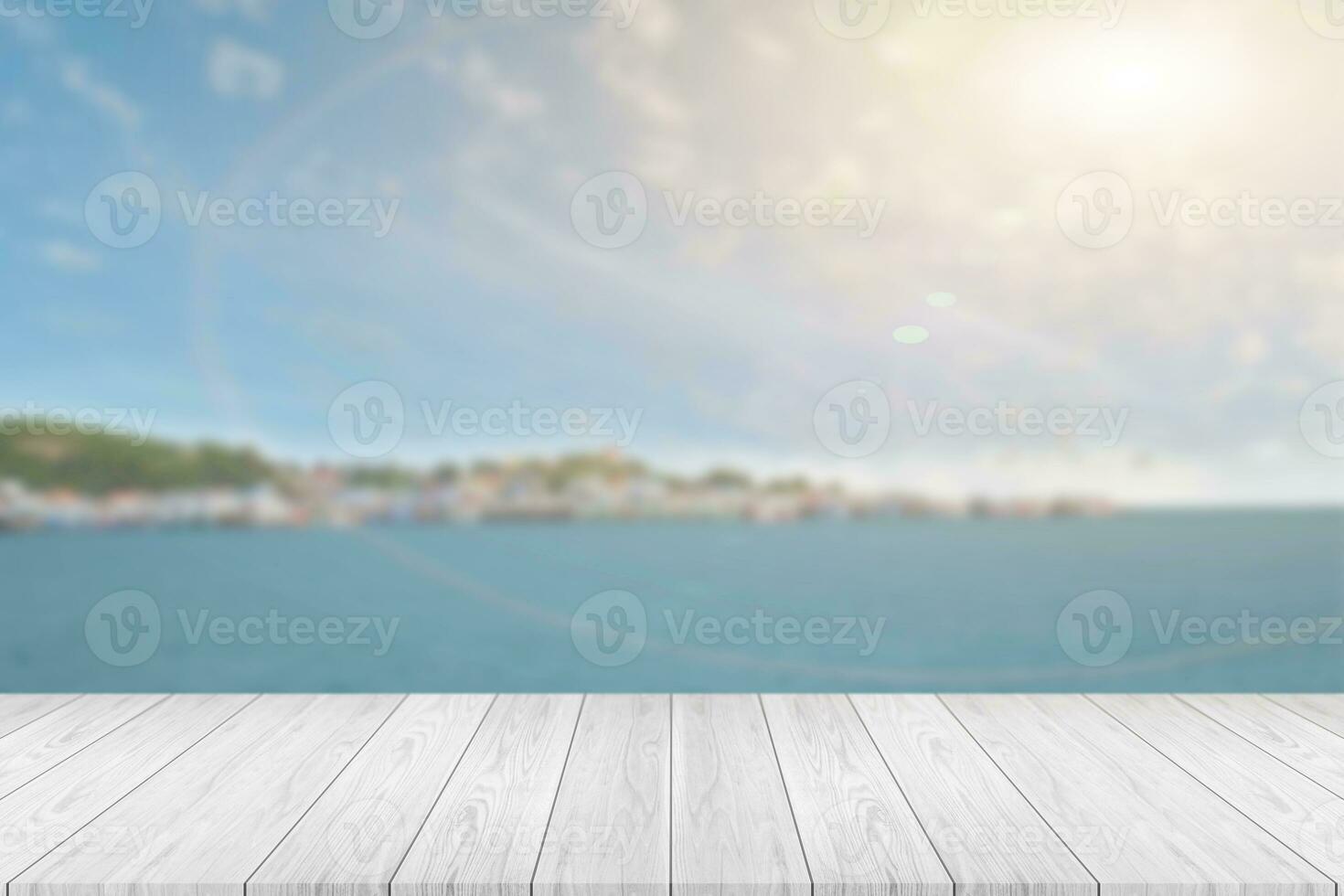 Perspective empty white wooden table on top over blur seascape background. For montage products display or design layout. photo