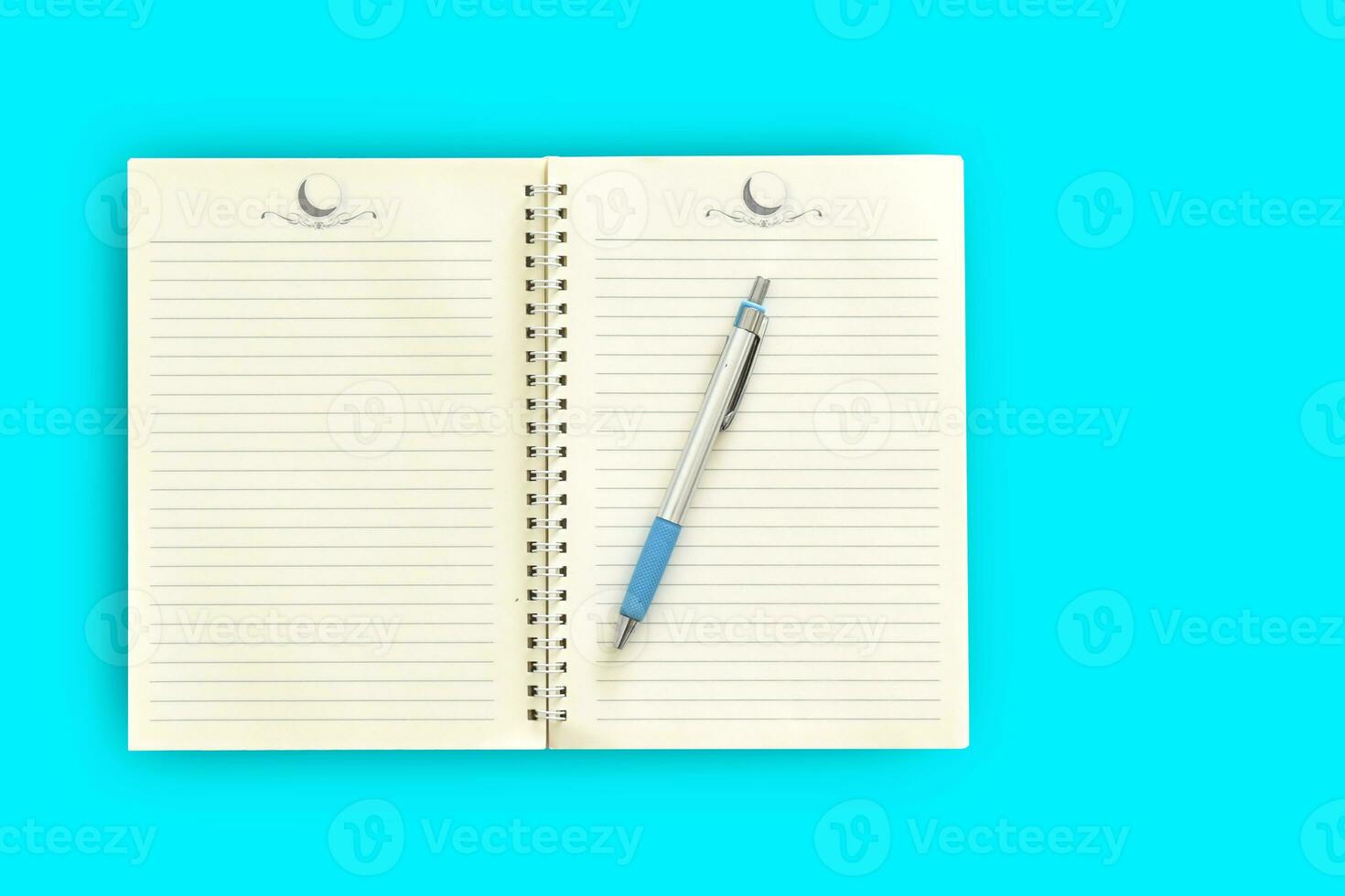 Notebook,pen on a blue background. top view copy space photo