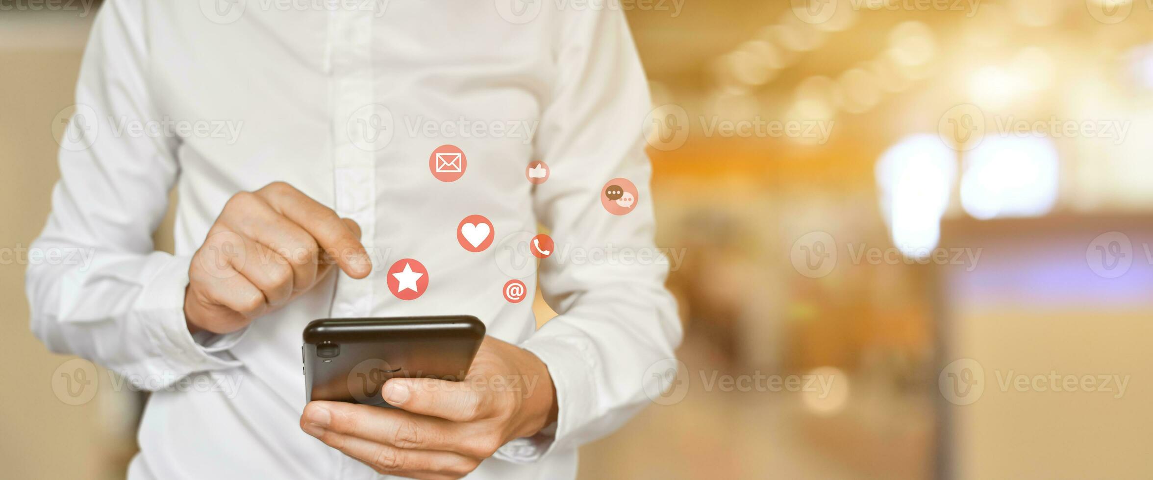 Close up of man using mobile smartphone with social, media icons. Marketing or business technology concept. photo