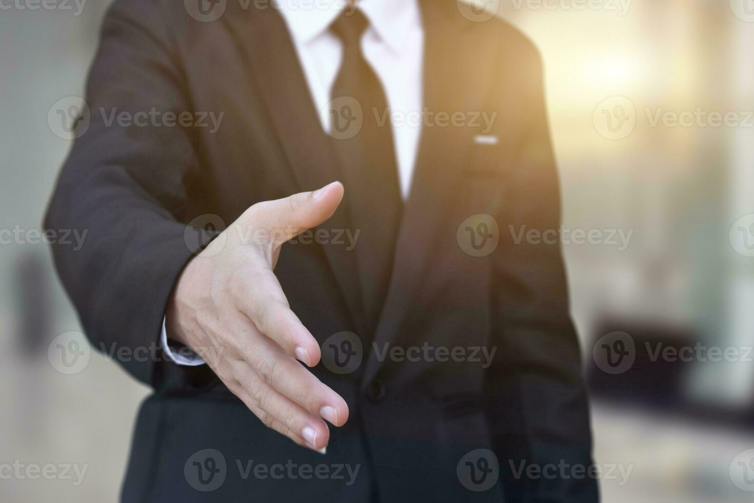 Businessman offering his hand for handshake in office. Concept of welcome for collaboration, introduction. Selective focus. photo