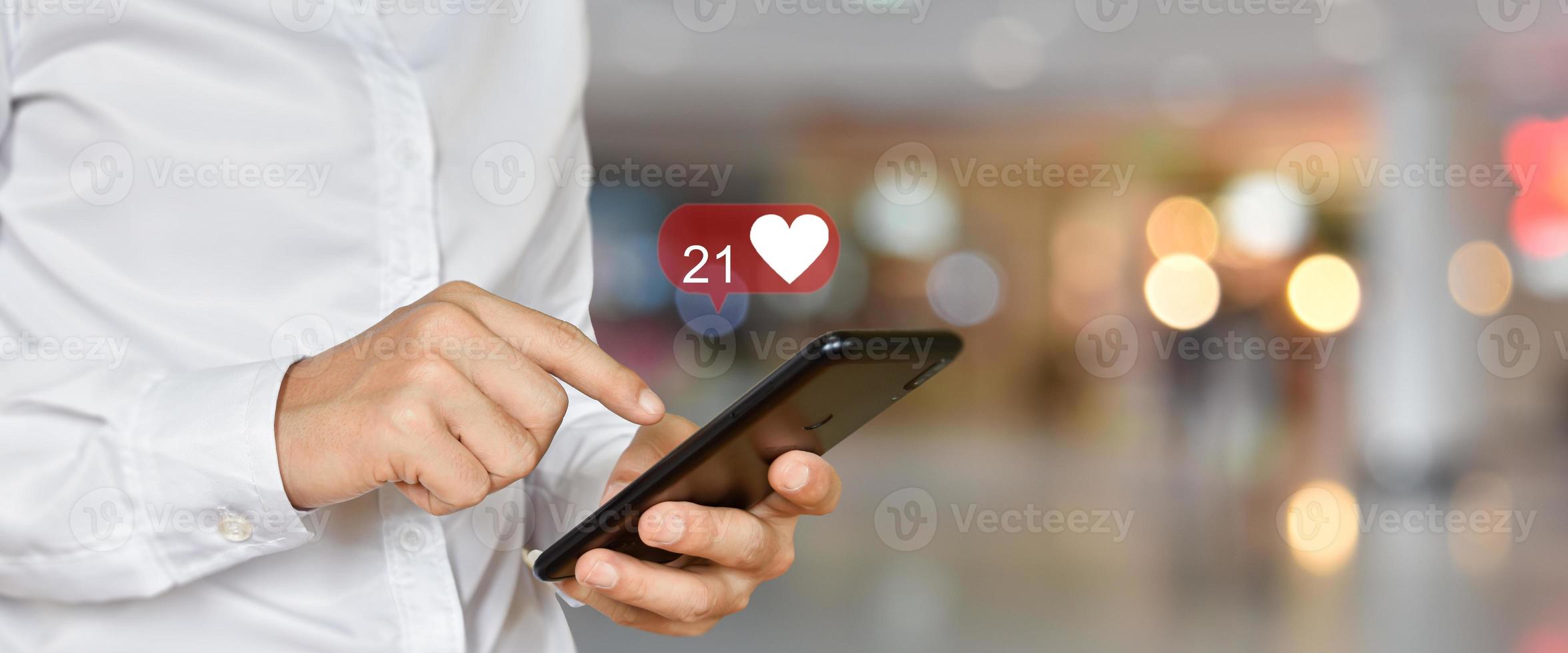 Close up of man using mobile smartphone with social, media icons. Marketing or business technology concept. photo