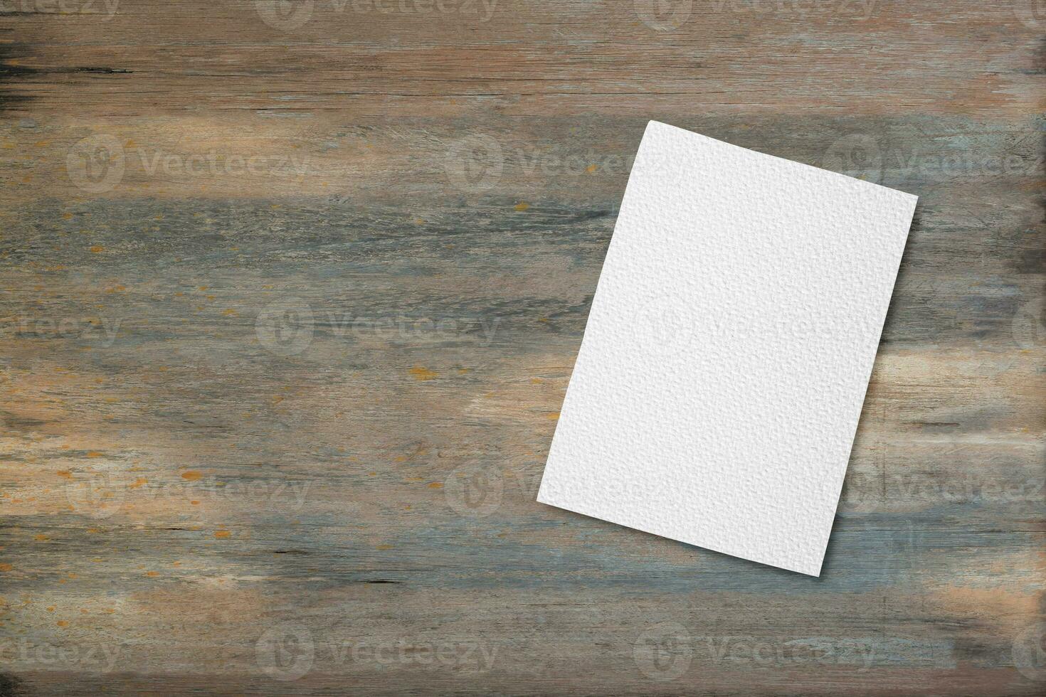 Blank white notebook pad on wood desk background with copy space. Top down photo