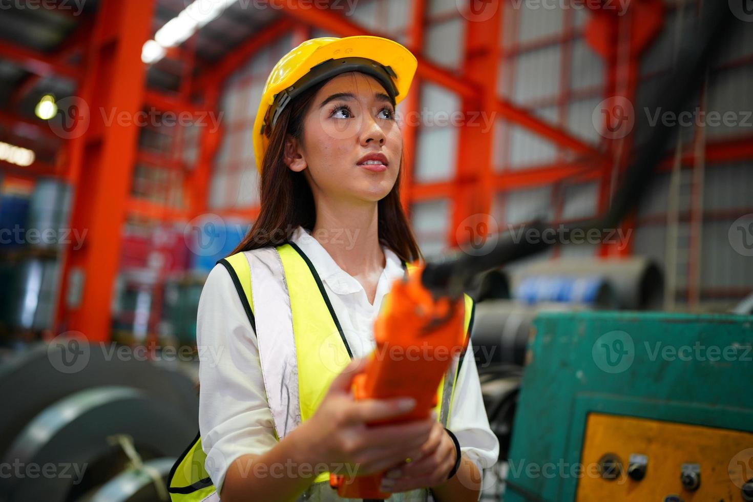 Female worker Foreman or worker work at factory site check up machine or products in site. Engineer or Technician checking Material or Machine on Plant. Industrial and Factory. photo