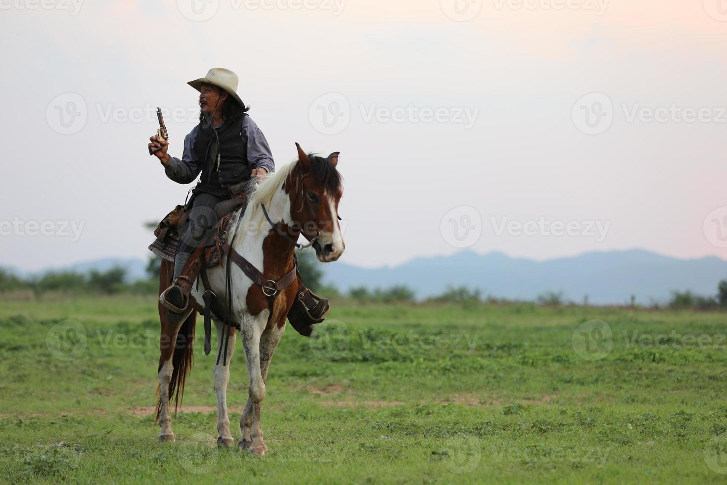 Silhouette Cowboy on horseback against a beautiful sunset, cowboy and horse at first light, mountain, river and lifestyle with natural light background photo