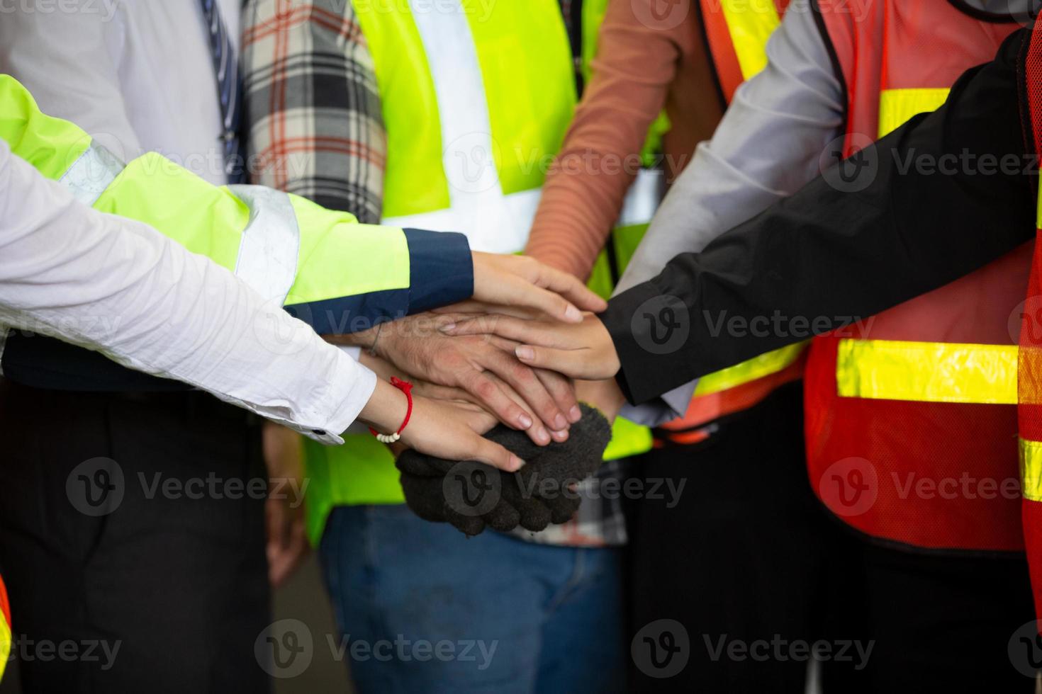 Stack of hands. Unity and teamwork concept. Close up side view of young business people putting their hands together photo