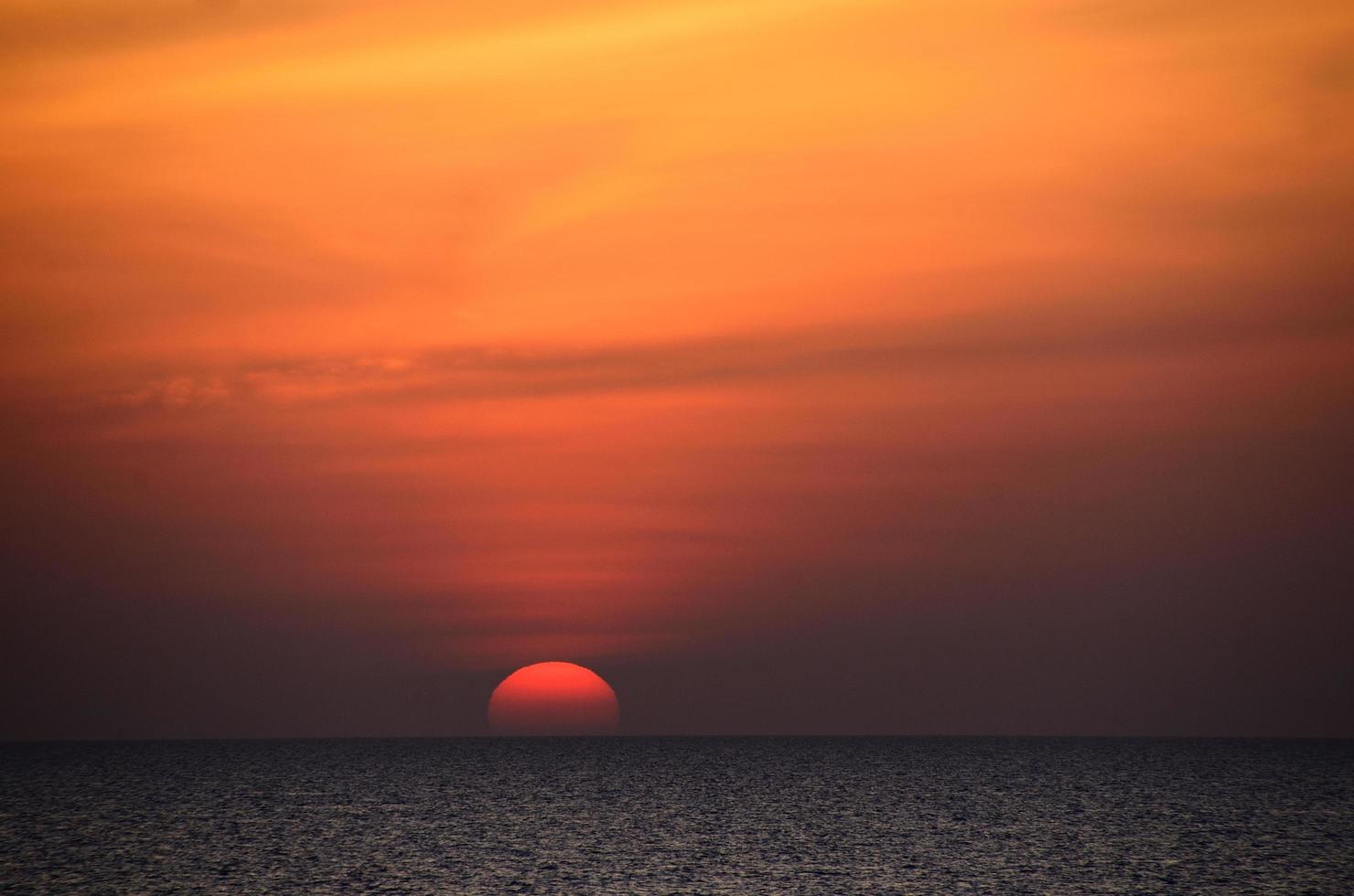 big sun with horizon sea photo