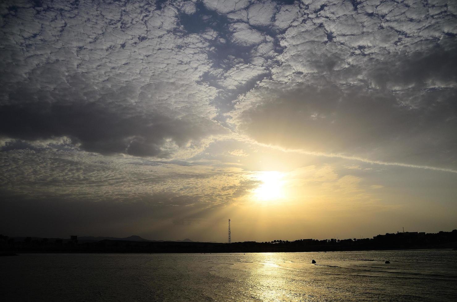 playa y hermosas nubes con sol foto