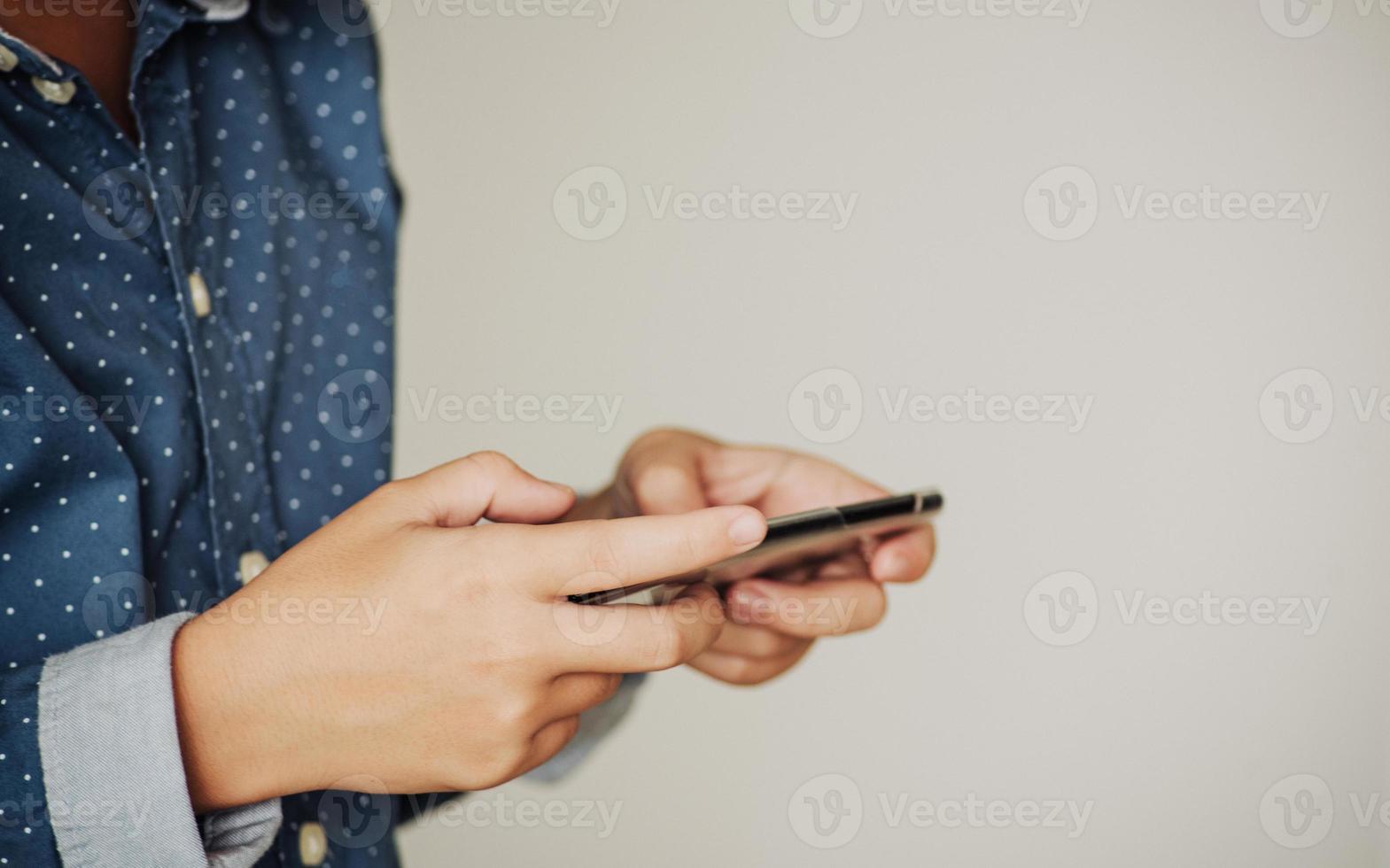 Boy playing games on smartphones, Boy hand holding a smartphone photo