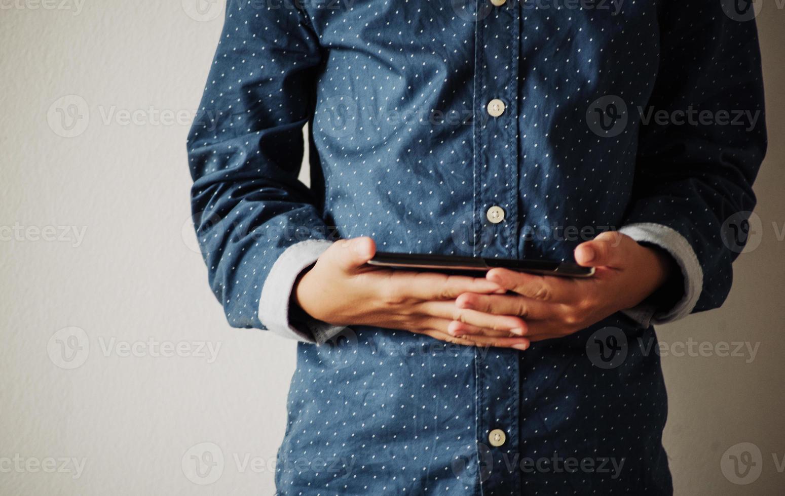 Boy playing games on smartphones, Boy hand holding a smartphone photo