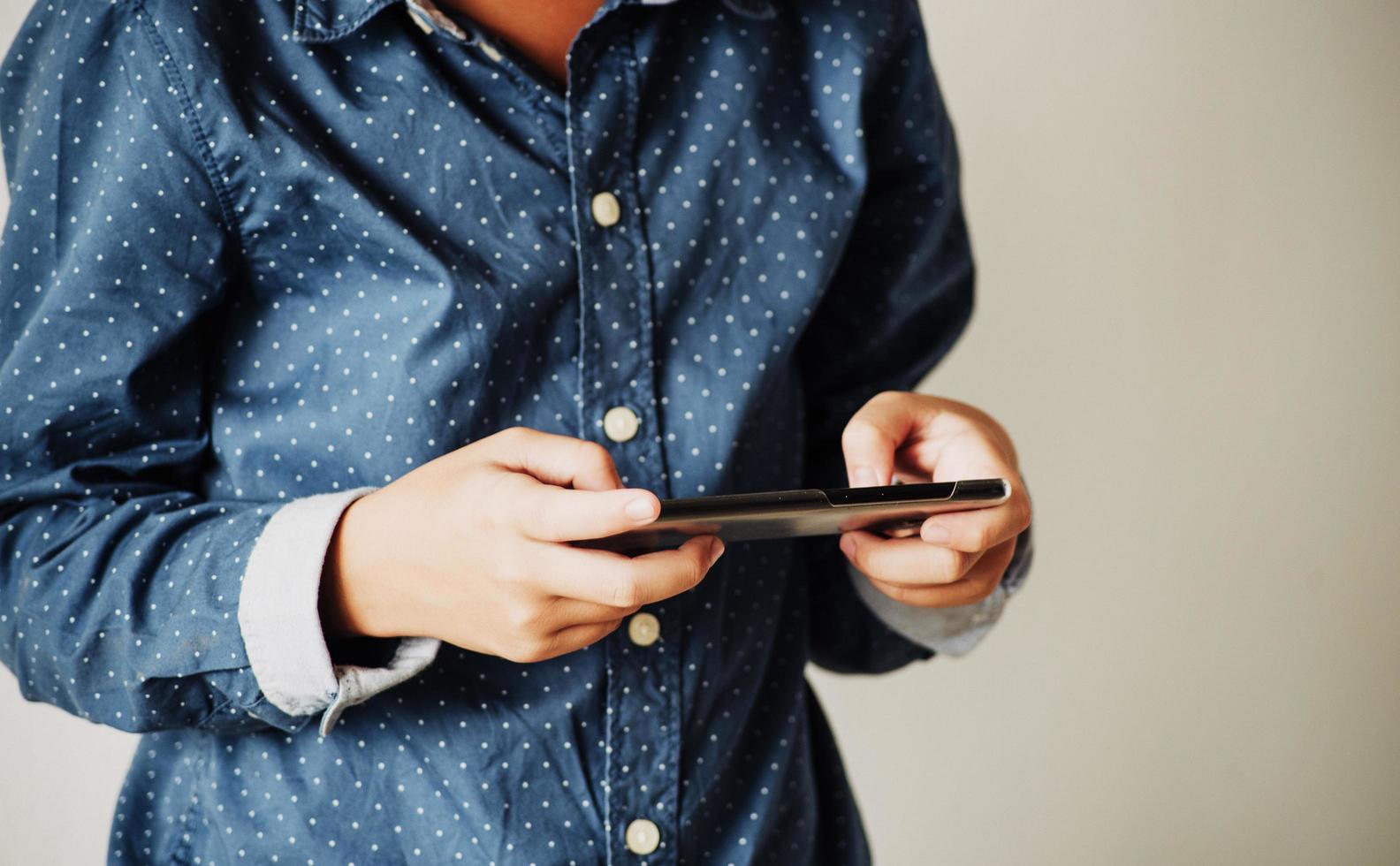 Boy playing games on smartphones, Boy hand holding a smartphone photo