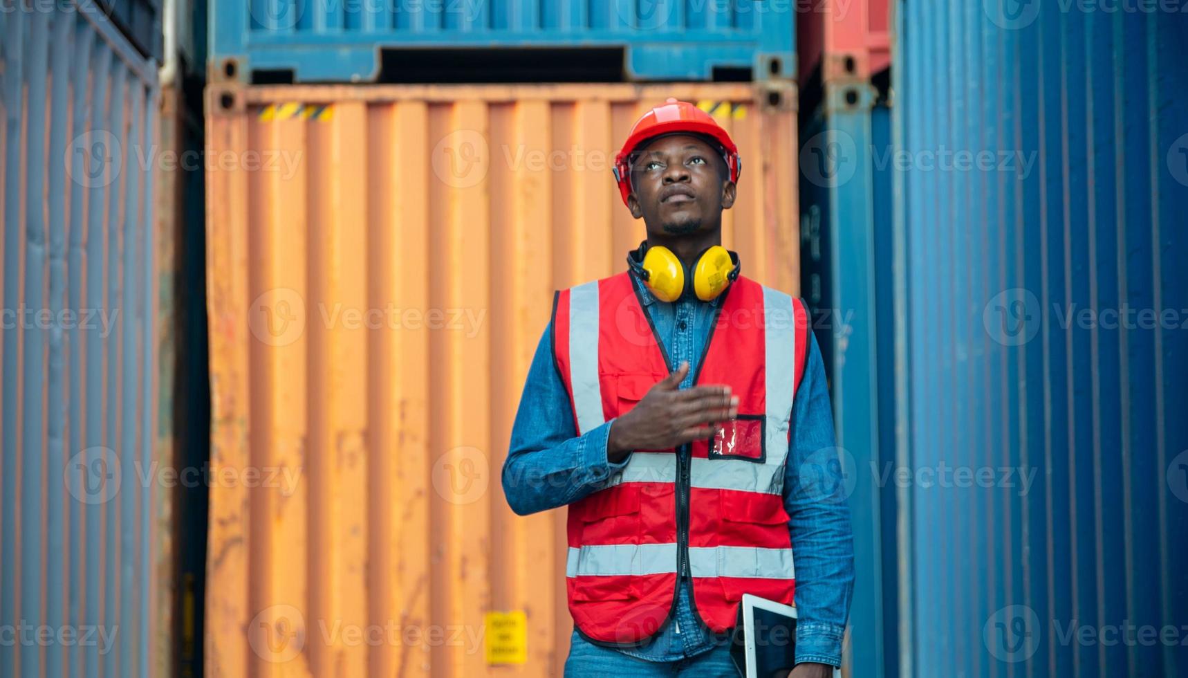 Engineer or supervisor checking and control loading Containers box from Cargo at harbor. Foreman control Industrial Container Cargo freight ship at industry. Transportation and logistic concept. photo