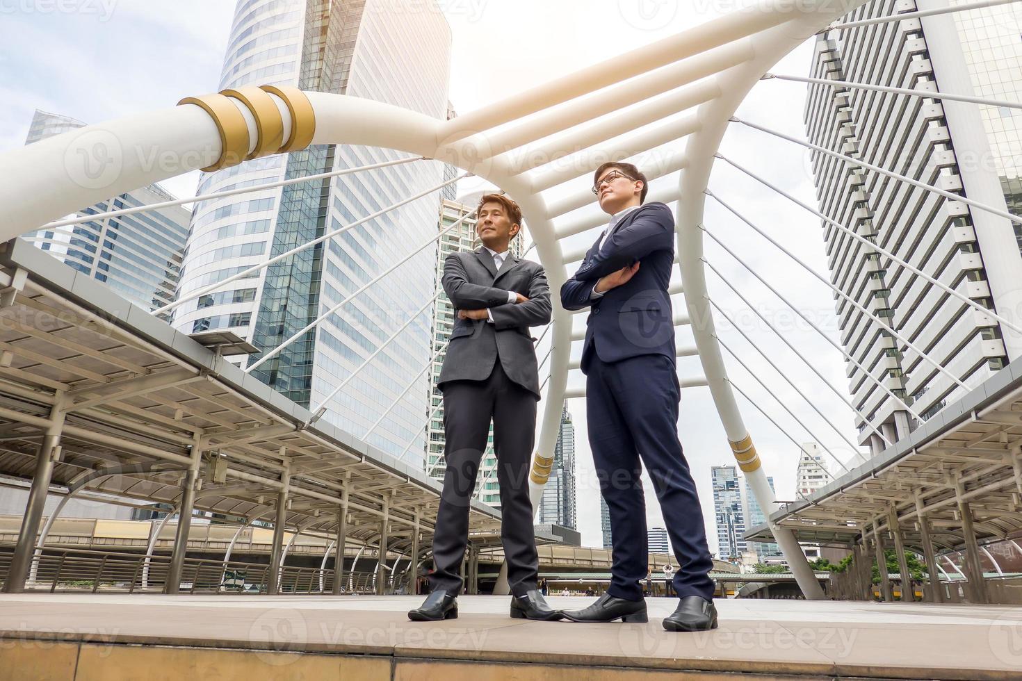 Successful business people standing together widen out showing strong relationship of worker community. A team of businessman and businesswoman expressing a strong group teamwork at the modern office. photo