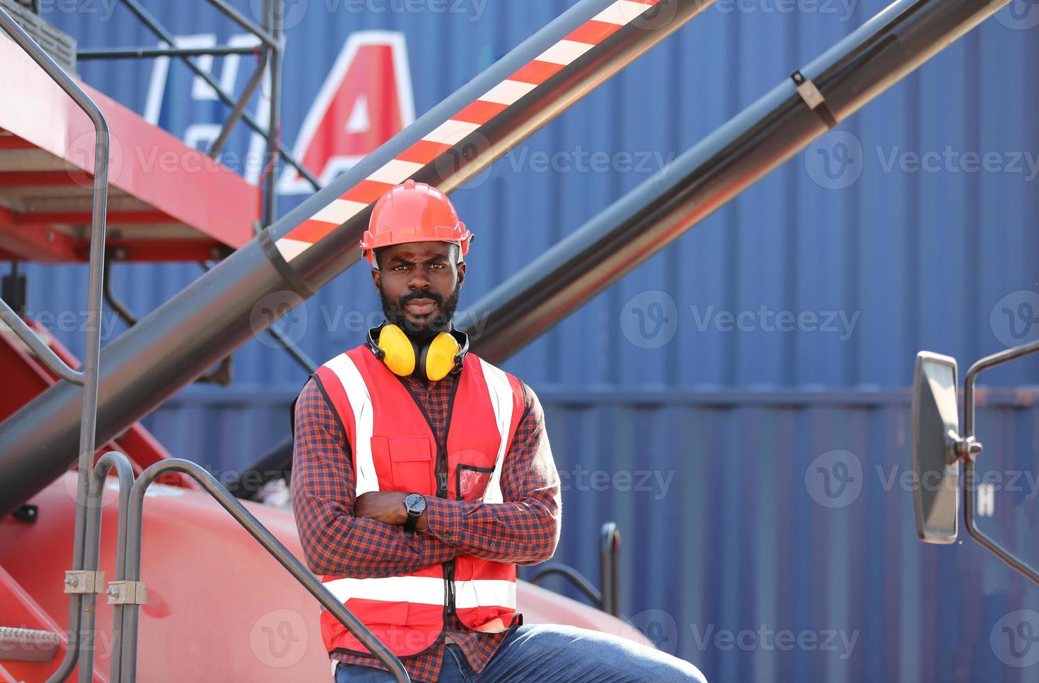 Foreman control loading Containers box from Cargo freight ship for import export. photo