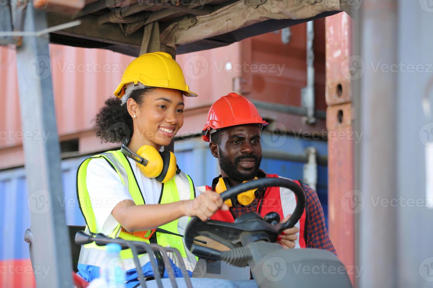 Foreman control loading Containers box from Cargo freight ship for import export. photo