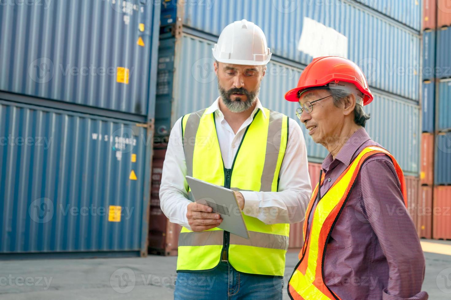 Foreman control loading Containers box from Cargo freight ship for import export. photo