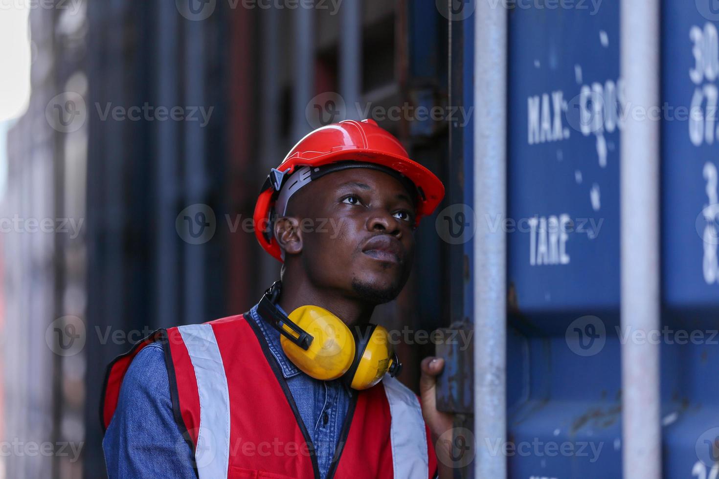 Engineer or supervisor checking and control loading Containers box from Cargo at harbor. Foreman control Industrial Container Cargo freight ship at industry. Transportation and logistic concept. photo