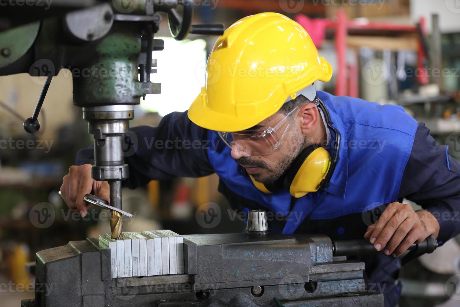 Professional industrial factory employee working with machine part, checking and testing industrial equipment and robot arms in large Electric electronics wire and cable manufacturing plant factory photo