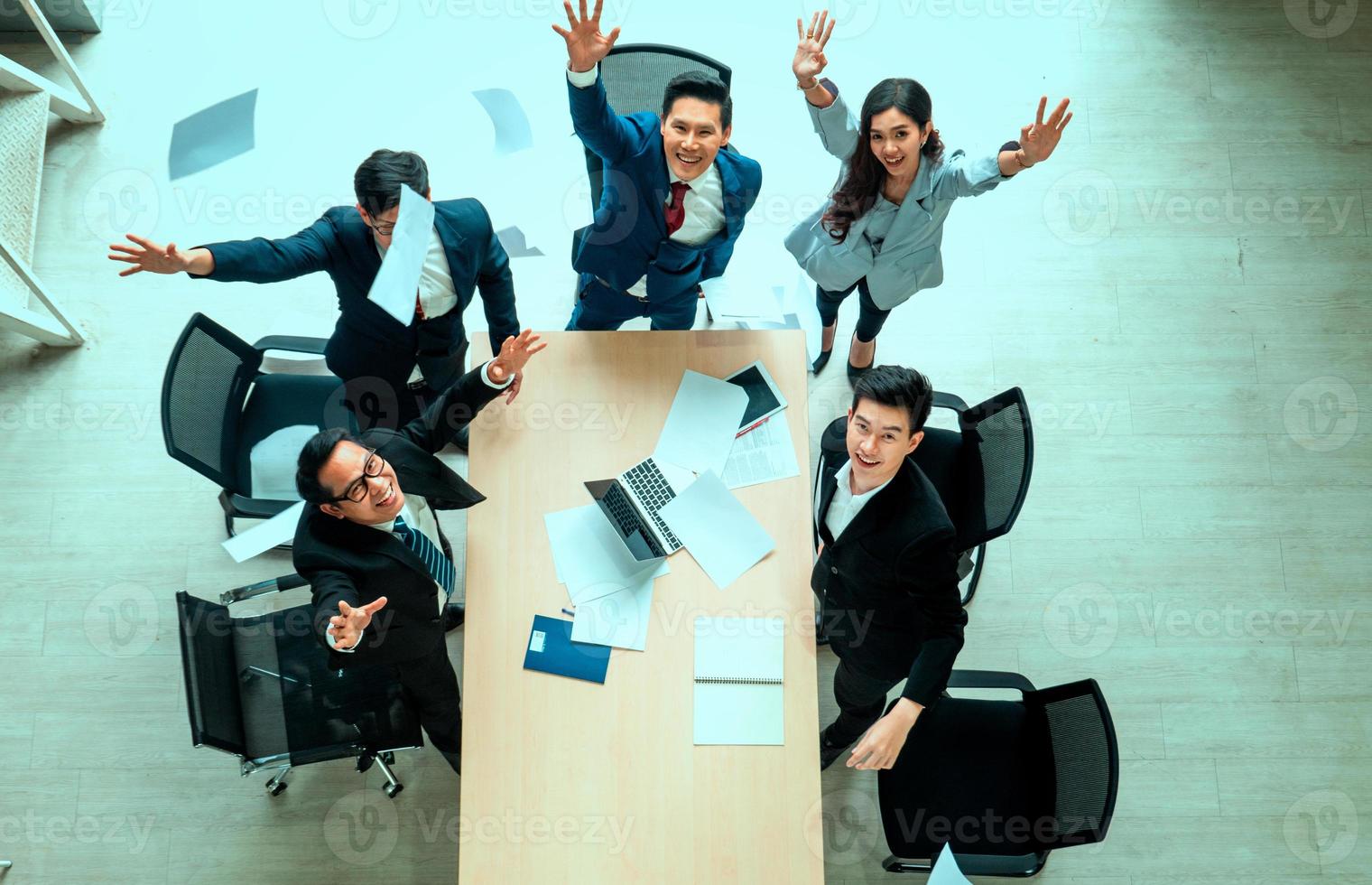 Top view on a group of businessman and businesswoman having a meeting and making a business commitment. photo