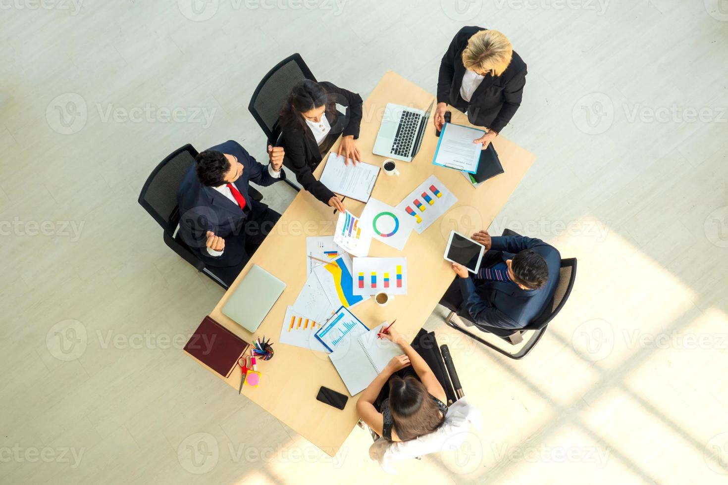 Top view on a group of businessman and businesswoman having a meeting and making a business commitment. photo