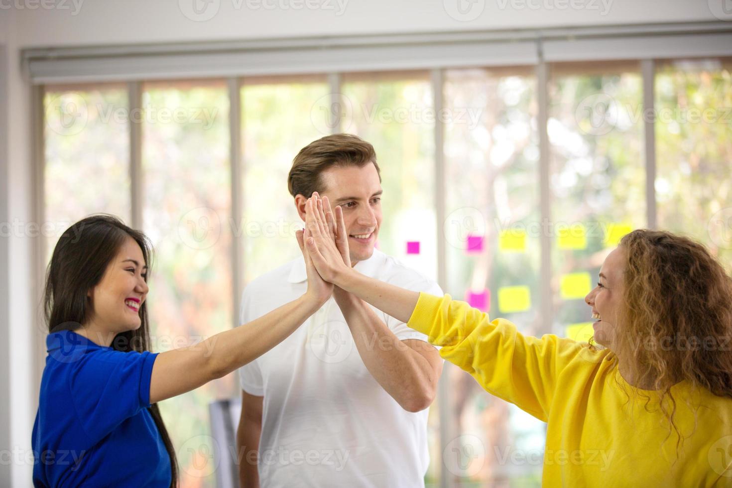 group young businessman, businesswoman people putting hands together, startup power to support, success on table at office, workplace. Teamwork, colleagues collaborate business concept. photo