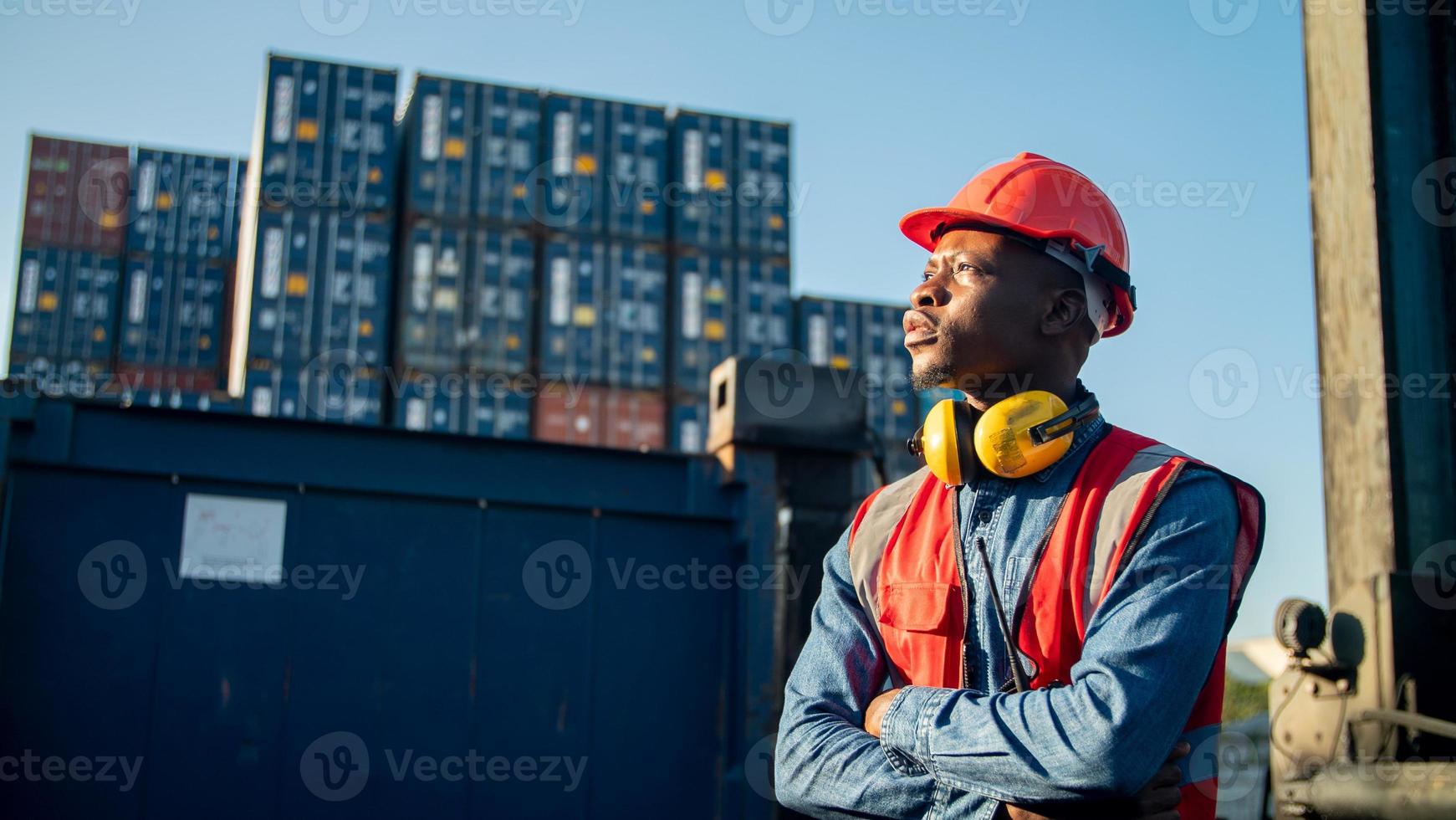 Foreman control loading Containers box from Cargo freight ship for import export. photo