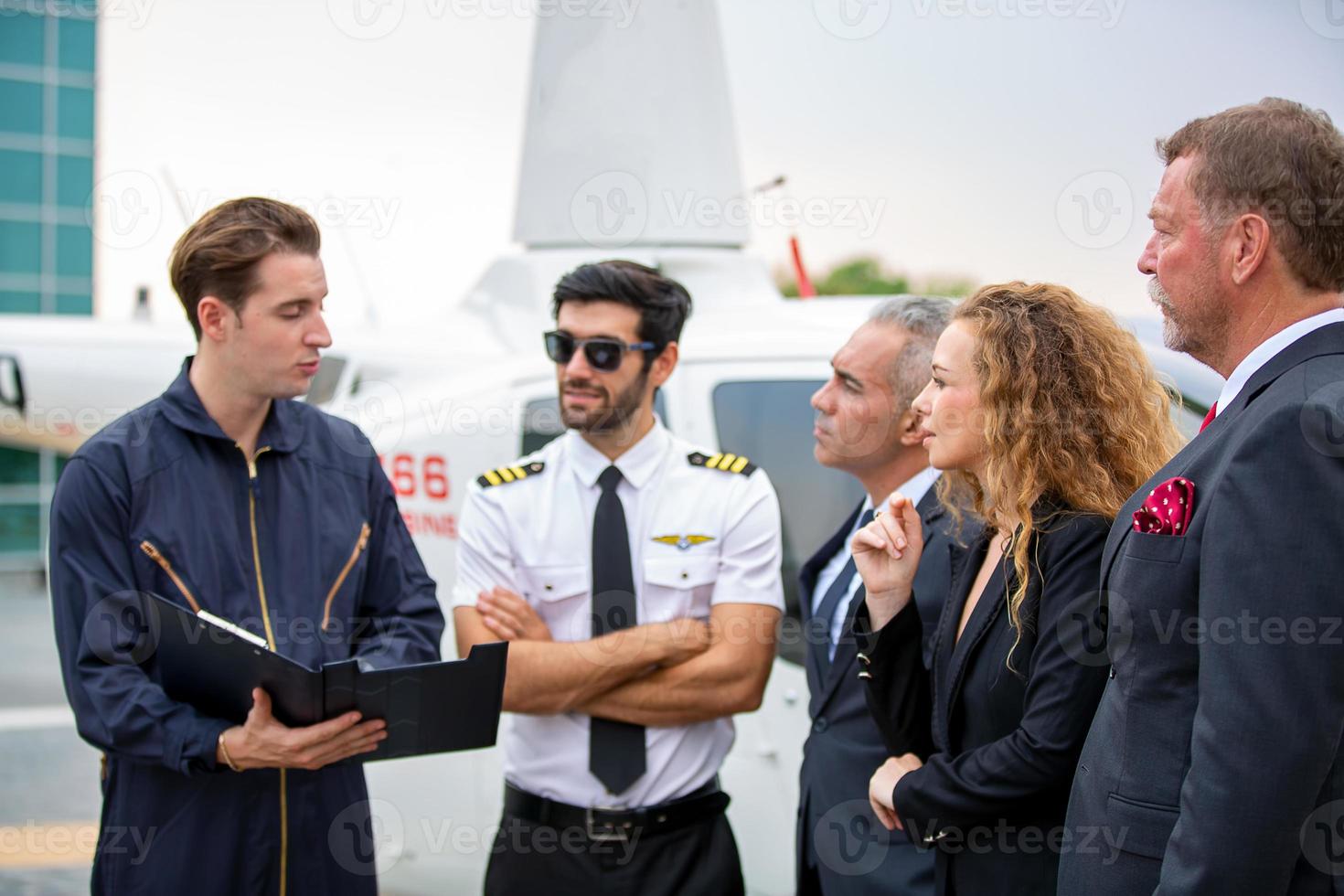 Successful business people standing together widen out showing strong relationship of worker community. A team of businessman and businesswoman expressing a strong group teamwork at the modern office. photo