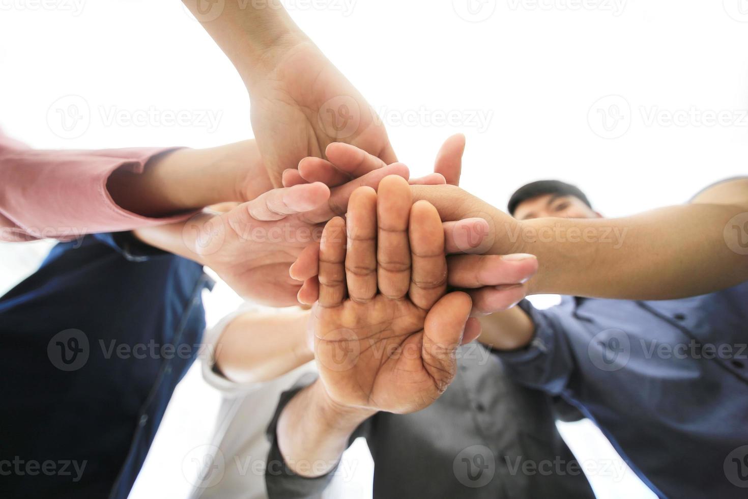 Successful business people standing together widen out showing strong relationship of worker community. A team of businessman and businesswoman expressing a strong group teamwork at the modern office. photo