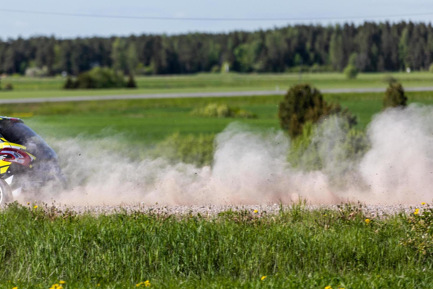 Rally car and gravel behind it. High speed racing photo