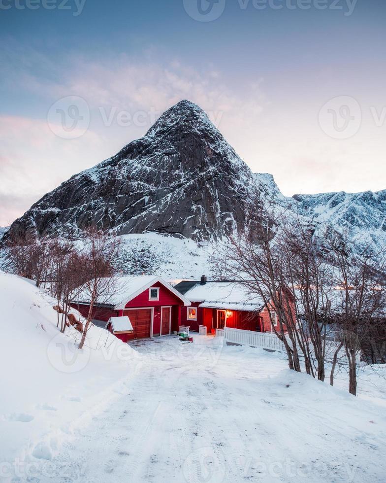 Red house with dry tree in mountain on winter photo