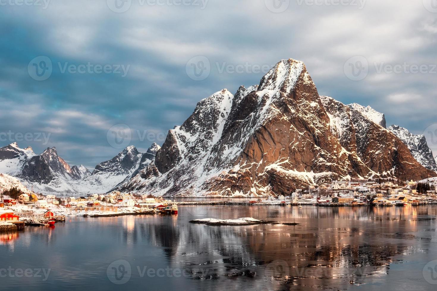 Snow mountain with scandinavian village on arctic ocean in winter photo