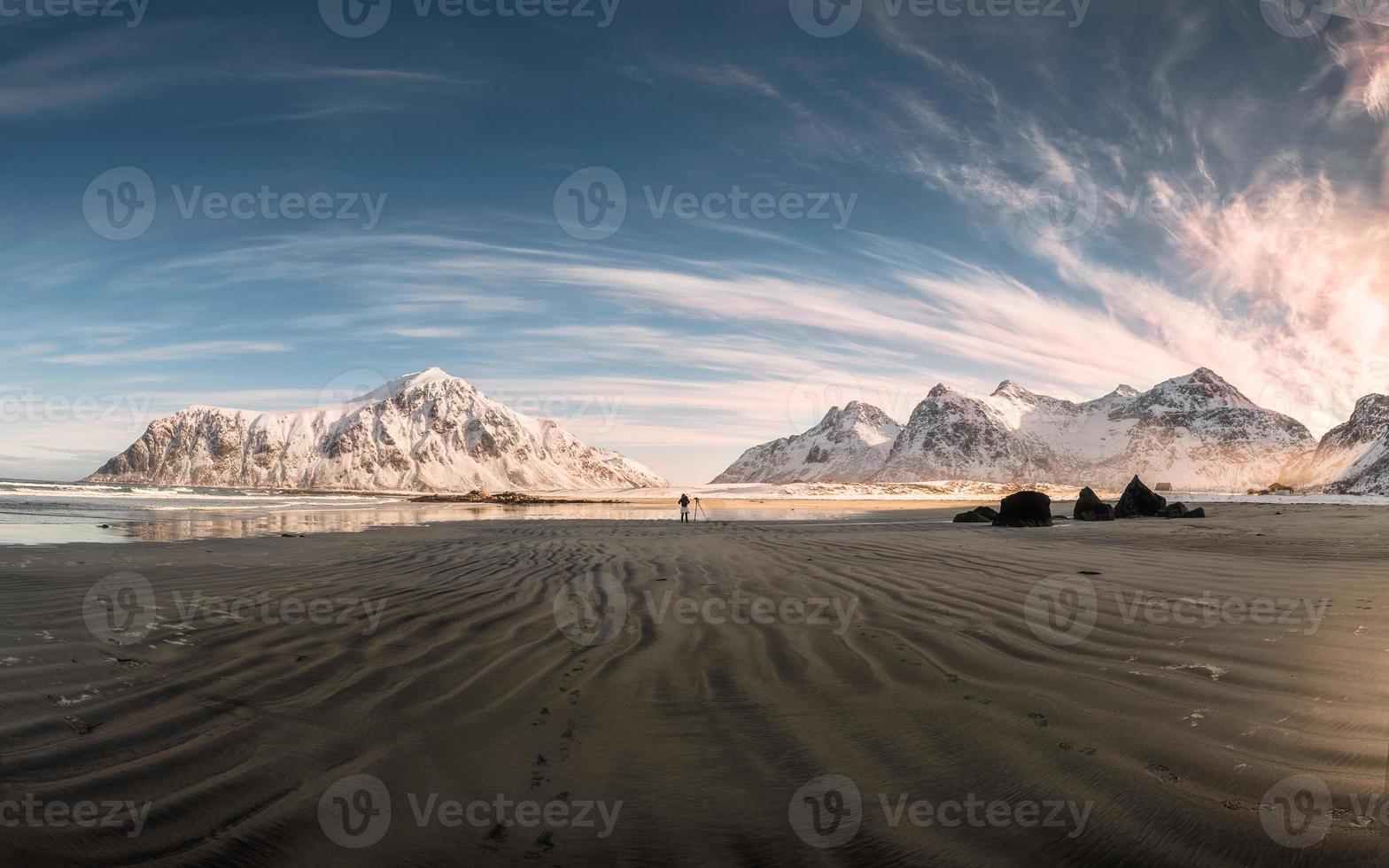 Panorama of Snow mountain range with sand furrows on coastline at Skagsanden beach photo